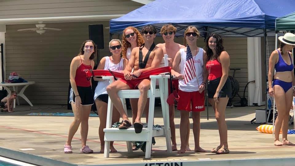Lifeguards standing around lifeguard station